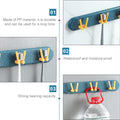 Modern wall-mounted bathroom shelf with hooks, perfect for hygienic toothbrush storage.