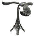 A hand demonstrating the Balancing Eagle Toy's stability by placing it on a fingertip, separate from its stand.
