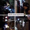 Person wearing LED flashlight gloves performing a task outdoors in the dark.