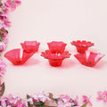 Variety of colorful plastic diyas from the 12-piece set, perfect for any celebration.