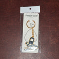 Packaging detail of golden Shivling keychain