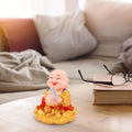 The peaceful expression of the Solar Buddha Car Ornament, ideal for dashboard decoration.