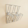 Wall-mounted stainless steel cup rack holding multiple drinkware
