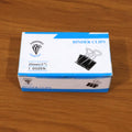 Multiple heavy duty black metal binder clips arranged for office use