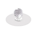 Crystal cabinet knob elegantly installed on a light wooden drawer for a modern look.