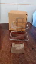 Sleek stainless steel self-adhesive wall mounted soap dish with integrated hooks.