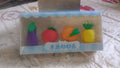 Assorted mini 3D fruit and vegetable erasers for kids' school supplies.