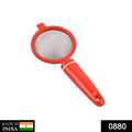 Hand holding a durable plastic tea strainer sieve for everyday kitchen use.