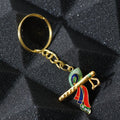 Close-up of Krishna metal keychain featuring flute and peacock feather motif
