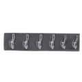 Stylish hooks rail placed in a bedroom, neatly organizing clothes and accessories.
