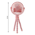 Portable fan mounted on flexible tripod stand in use outdoors