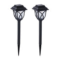 FitFuzion solar pathway lights casting bright, artistic patterns on a dark garden path, enhancing outdoor decor.