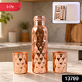 The elegant copper water bottle and two glasses, presented as a thoughtful gift set.