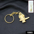Close-up of golden Shivling metal keychain showing detailed craftsmanship