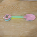 Close-up of colorful plastic sand digging tools for kids