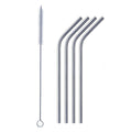 Bent stainless steel straw elegantly placed in a clear drinking glass.