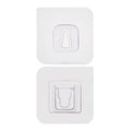 Two white no-drill adhesive hooks mounted on a smooth, clean wall surface.
