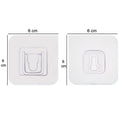 A robust heavy-duty adhesive hook in use, holding multiple items securely.