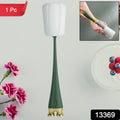 Multifunctional silicone bottle cleaning brush effectively cleaning a tall glass bottle.