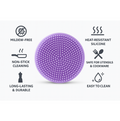 Silicone dish scrubber gently cleaning a delicate glass without scratches.