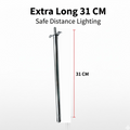 Stainless steel gas lighter igniting a kitchen stove burner.