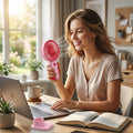 Mini rechargeable fan on desk with laptop, portable cooling