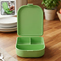 Compact medicine storage case with flip lid on a clean surface.
