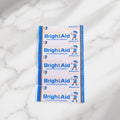 BrightAid medicated dressing strips in sterile packaging.