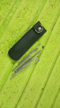 A person safely using a stainless steel ear pick from the reusable ear cleaning tool set.