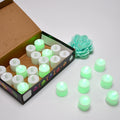 A pack of 24 green flameless LED tealights ready for use.