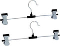 Organized wardrobe section showcasing clothes neatly hung on stainless steel hangers.