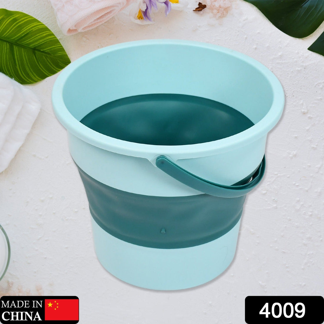 A blue foldable water bucket with a handle, shown partially collapsed.