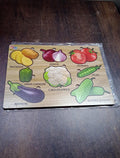 Close-up of smooth, chunky wooden vegetable puzzle pieces, safe for little hands.
