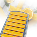 Hand demonstrating the easy push-out feature of the ice stick tray.