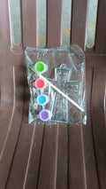 Assorted acrylic paint tubes and a plastic stencil for creative projects.