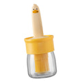 A side view of the transparent oil dispenser bottle, emphasizing its sleek kitchen design.