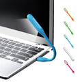 USB LED Light Lamp with a book, highlighting its use for reading.