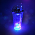 Side view of the plastic astronaut tumbler with its LED base illuminated, perfect for kids.