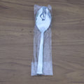 Stacked stainless steel dining spoons placed in a home kitchen setting