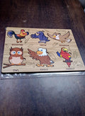 Wooden Bird Puzzle pieces laid out, ready for assembly by a young learner on the board.