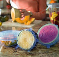 Airtight silicone food cover stretching over a bowl of fresh vegetables.