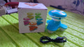 The portable massager placed on a travel bag, highlighting its travel-friendly size.