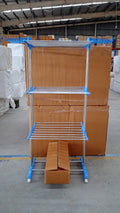 Metallic drying rack with wheels shown in folded position for storage