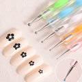 Textured grip on a nail art pen for better handling.