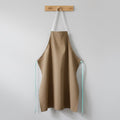 Chef apron shown alongside cooking utensils