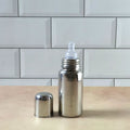 Soft silicone nipple on a stainless steel infant milk bottle