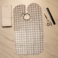 Adjustable neck closure on barber cape for secure fit during hair trims