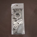 Lifestyle shot of a motorcycle silhouette metal keychain attached to a set of keys.