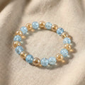 Close-up of glossy dual-tone beads on crystal stretch bracelet