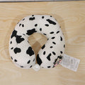 Playful cow print travel neck pillow for restful journeys